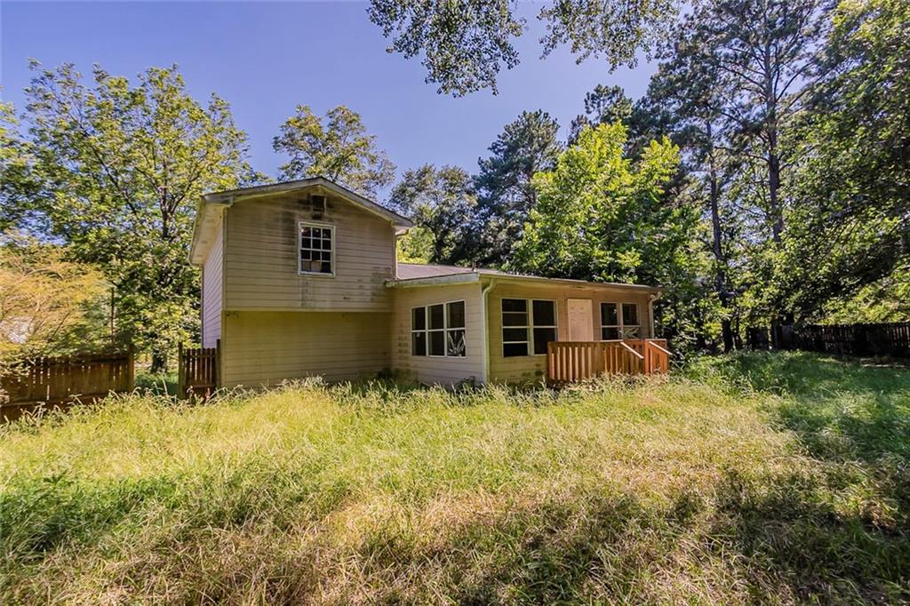 926 Bell Road Southeast Conyers, GA 30094 - Photo 23 of 30 a house is sitting in middle of the green field