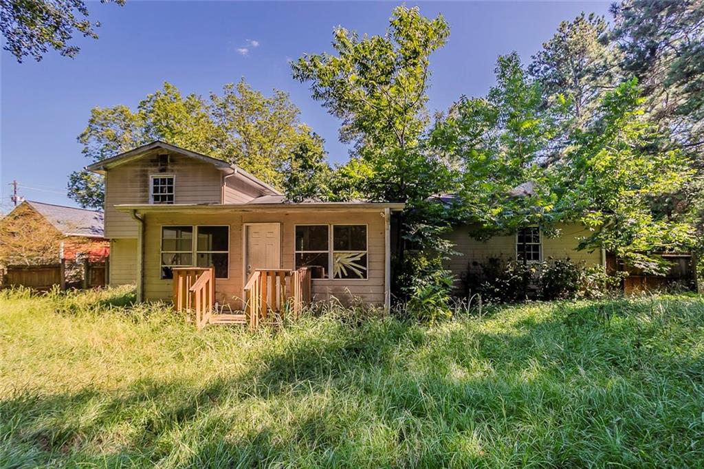 926 Bell Road Southeast Conyers, GA 30094 - Photo 26 of 30 a front view of house with yard and trees in the background