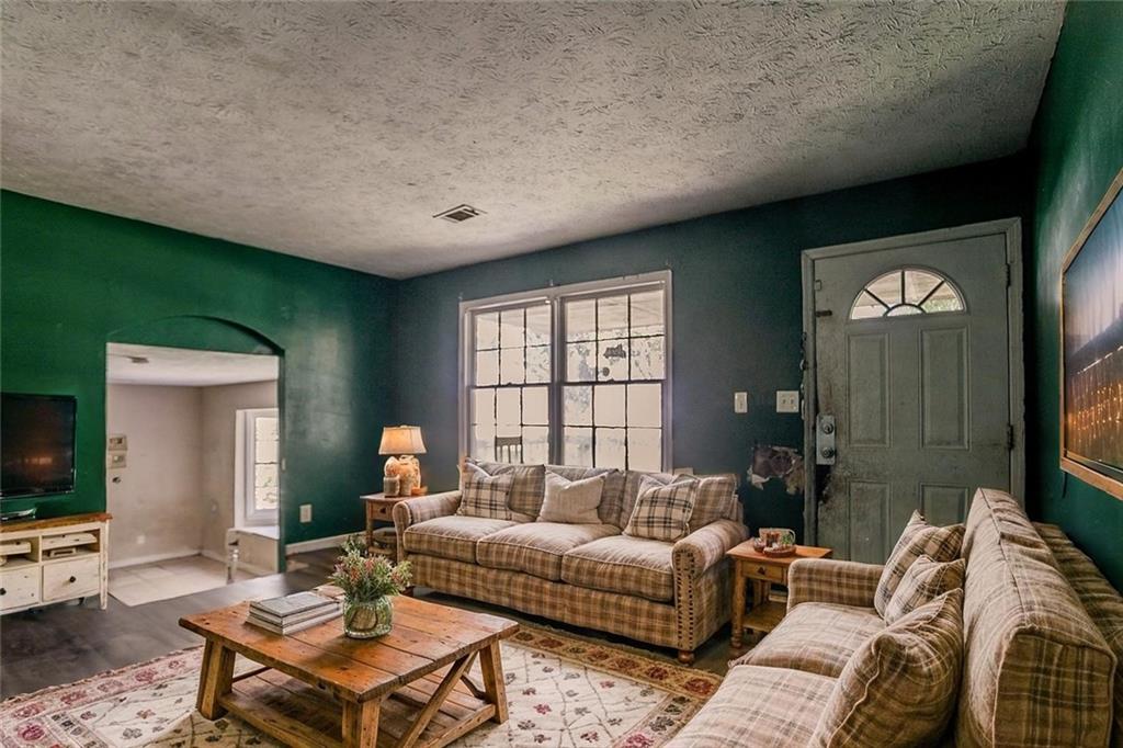 926 Bell Road Southeast Conyers, GA 30094 - Photo 4 of 30 a living room with furniture a flat screen tv and a large window