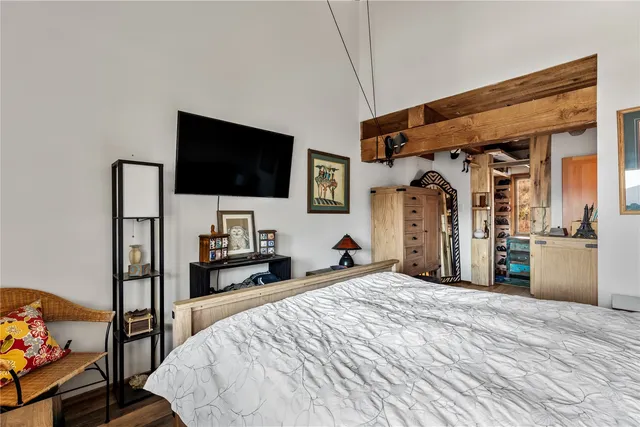 a bedroom with a bed and a flat screen tv