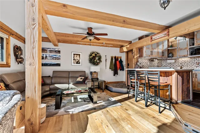 a living room with lots of furniture and kitchen view