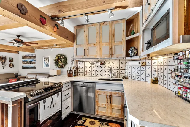 a kitchen with stainless steel appliances granite countertop a stove and a sink