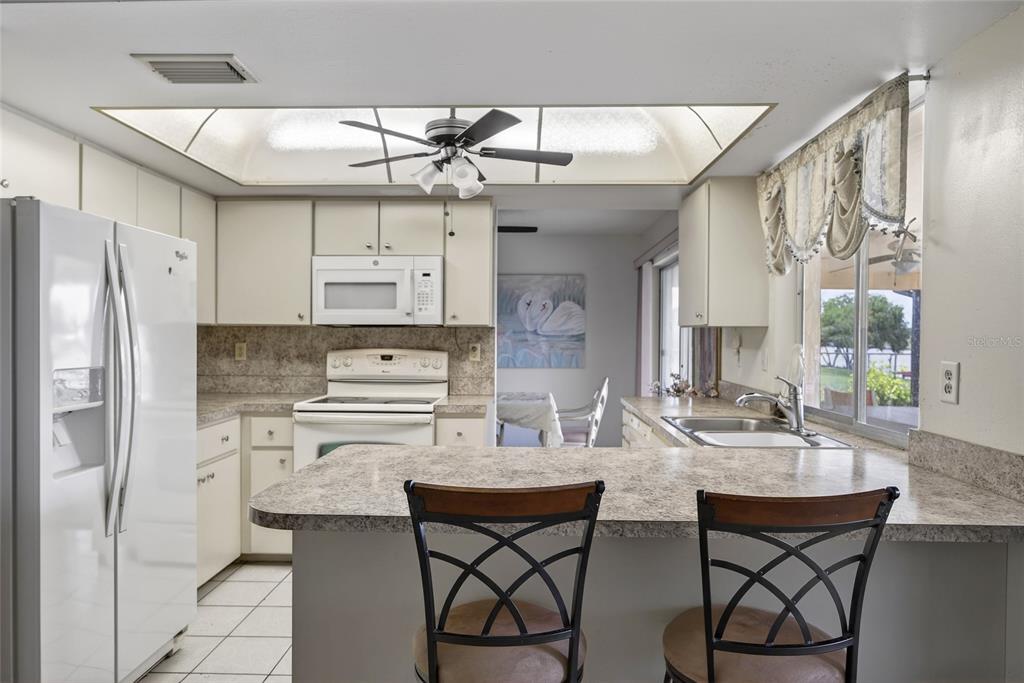 2484 Broad Ranch Drive Port Charlotte, FL 33948 - Photo 12 of 43 a kitchen with stainless steel appliances a sink stove and refrigerator