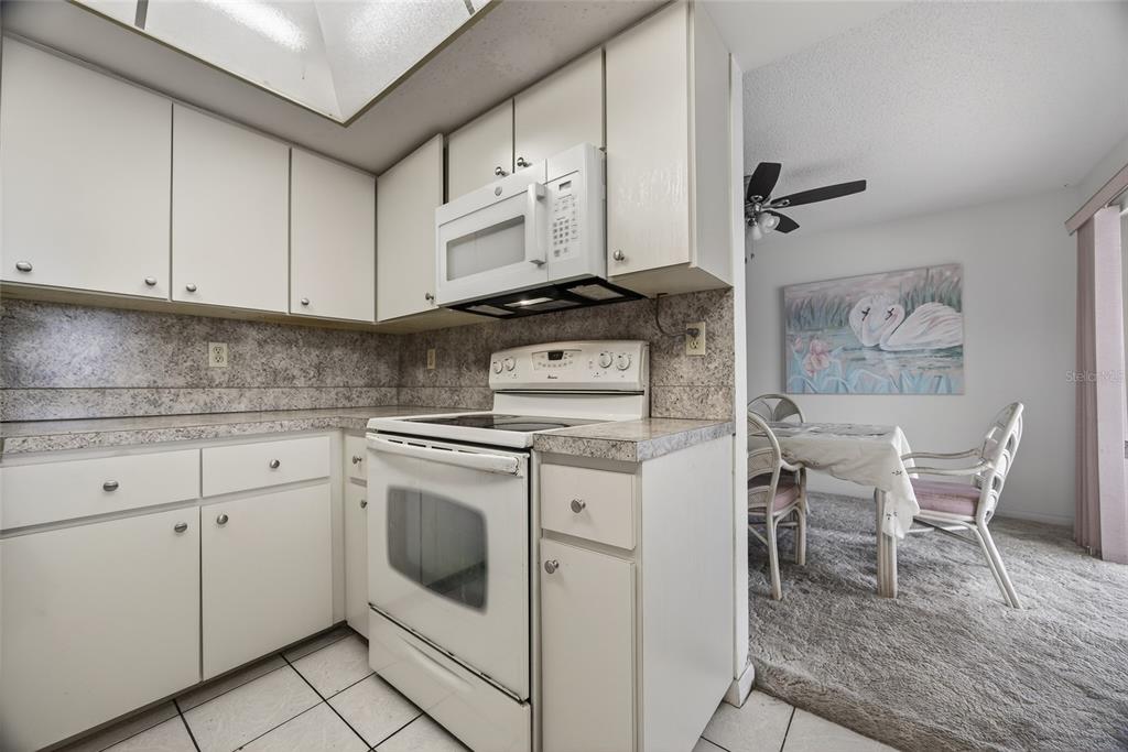 2484 Broad Ranch Drive Port Charlotte, FL 33948 - Photo 15 of 43 a kitchen with white cabinets and white appliances