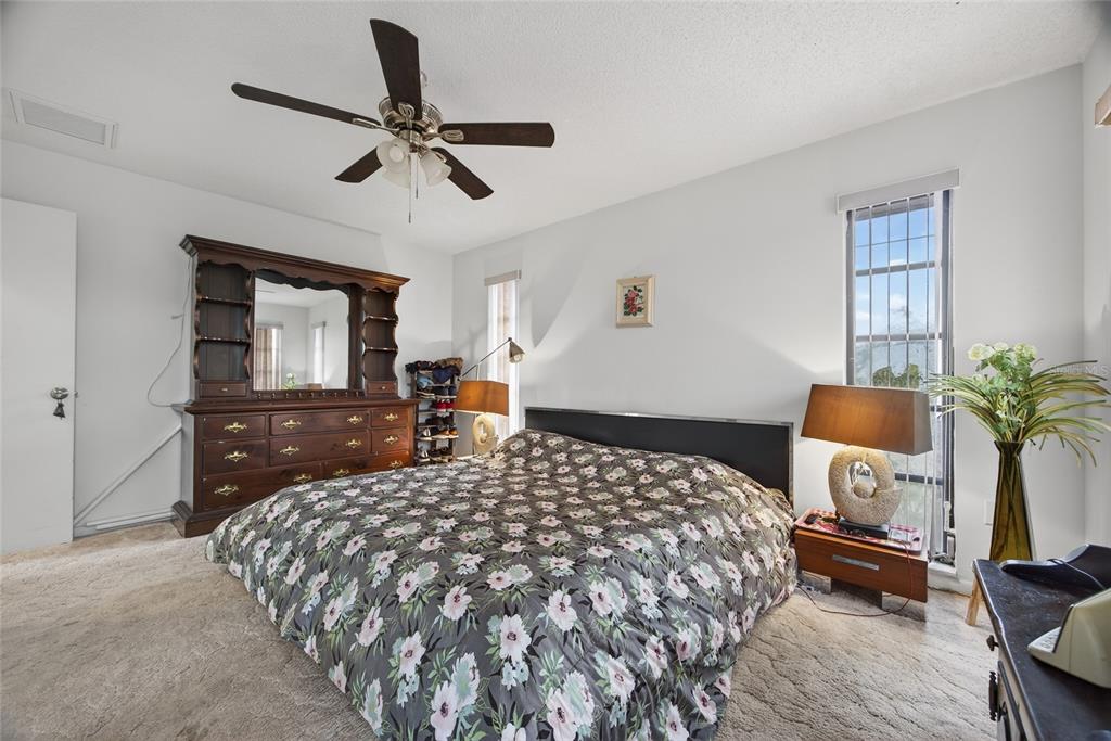 2484 Broad Ranch Drive Port Charlotte, FL 33948 - Photo 17 of 43 a bedroom with a bed and wooden floor