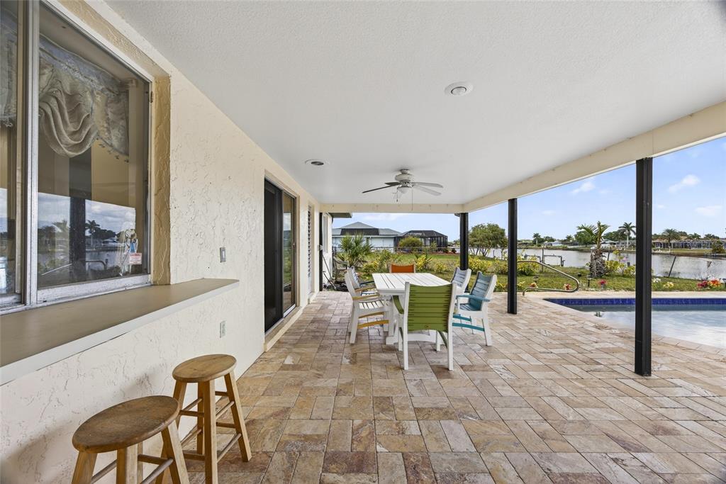 2484 Broad Ranch Drive Port Charlotte, FL 33948 - Photo 22 of 43 a dining room with furniture and a floor to ceiling window