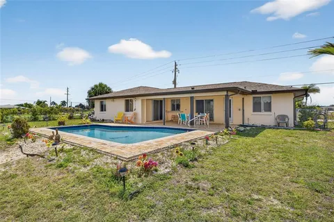 a very nice looking house with a large pool and a yard