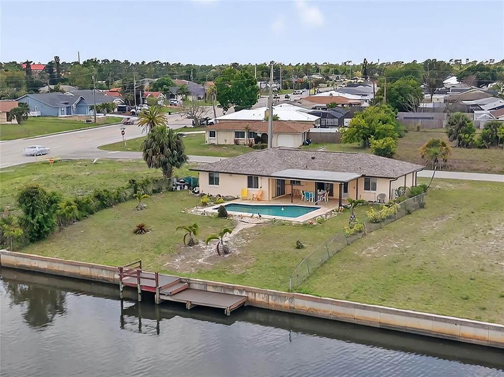 2484 Broad Ranch Drive Port Charlotte, FL 33948 - Photo 33 of 43 an aerial view of a house with a garden potted plants and large tree