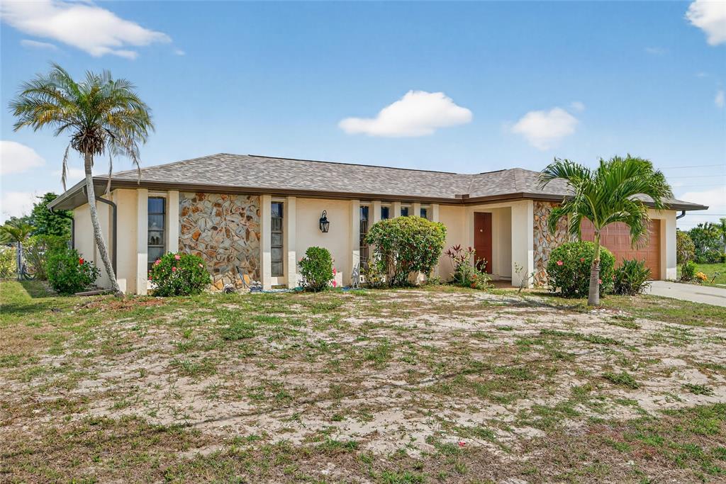 2484 Broad Ranch Drive Port Charlotte, FL 33948 - Photo 42 of 43 a front view of a house with garden