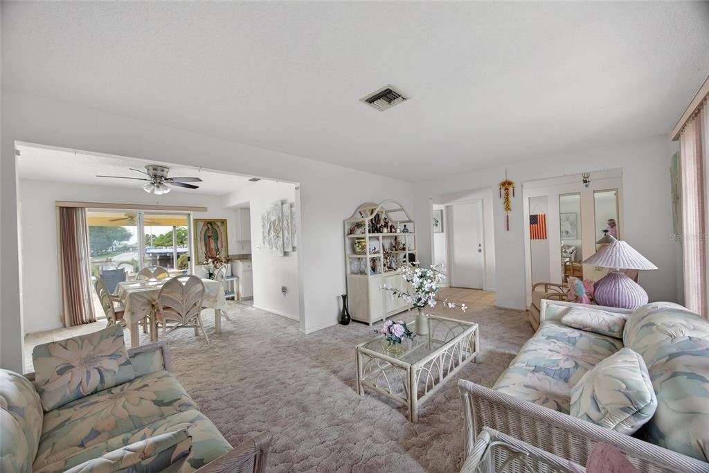 2484 Broad Ranch Drive Port Charlotte, FL 33948 - Photo 6 of 43 a living room with furniture and a large window