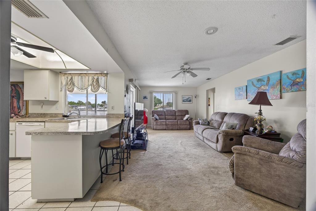 2484 Broad Ranch Drive Port Charlotte, FL 33948 - Photo 9 of 43 a living room with furniture and a kitchen view