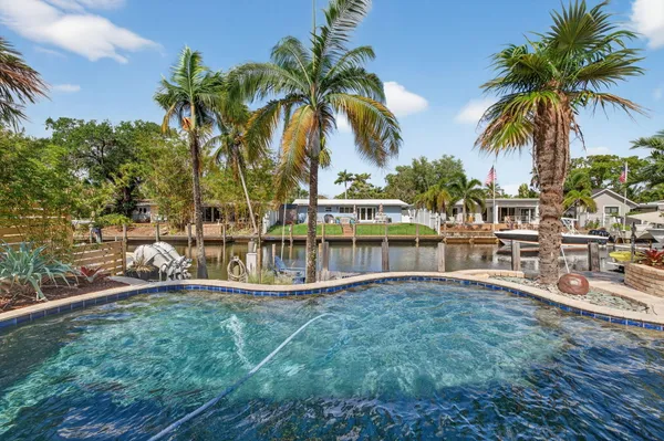 a view of a swimming pool with a table and chairs