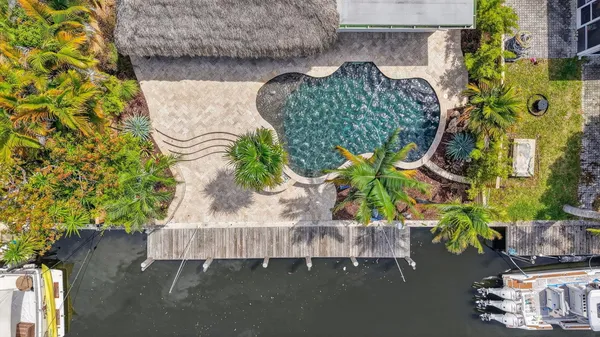 a view of house with swimming pool and a patio