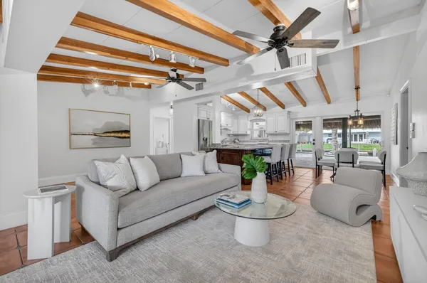 a living room with furniture and a mirror