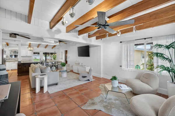 a living room with furniture and a ceiling fan