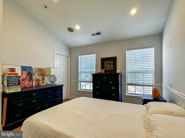 a bedroom with a bed and a dresser