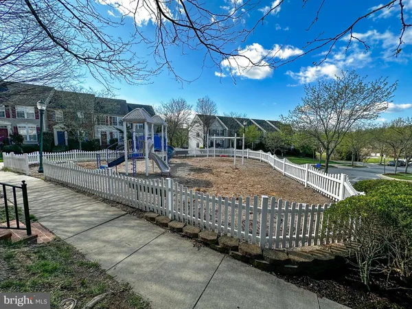 a view of a pathway with a wrought fence