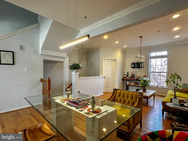a living room with furniture and kitchen view