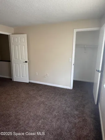 a view of an empty room with closet area