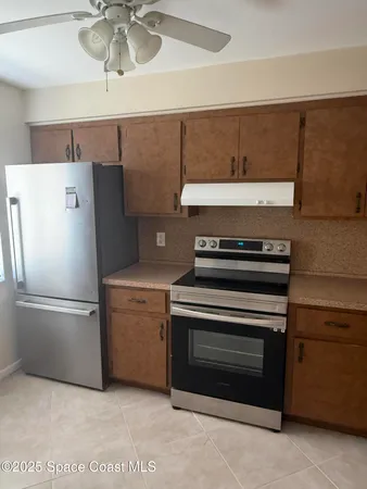 a kitchen with a stove and a refrigerator