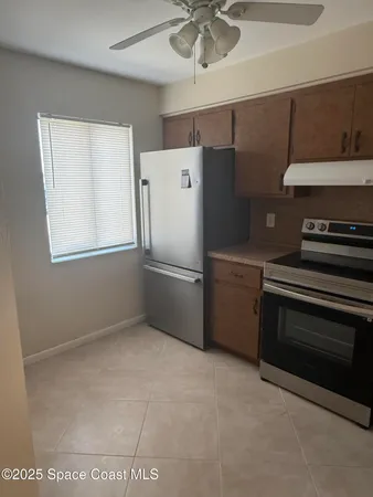 a kitchen with a stove and a refrigerator