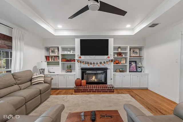 a living room with furniture a flat screen tv and a fireplace
