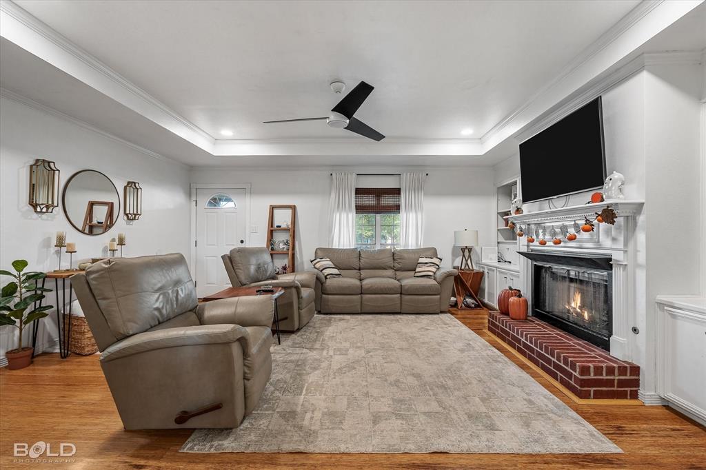 3804 Farmridge Road Keithville, LA 71047 - Photo 17 of 36 a living room with furniture a flat screen tv and a fireplace
