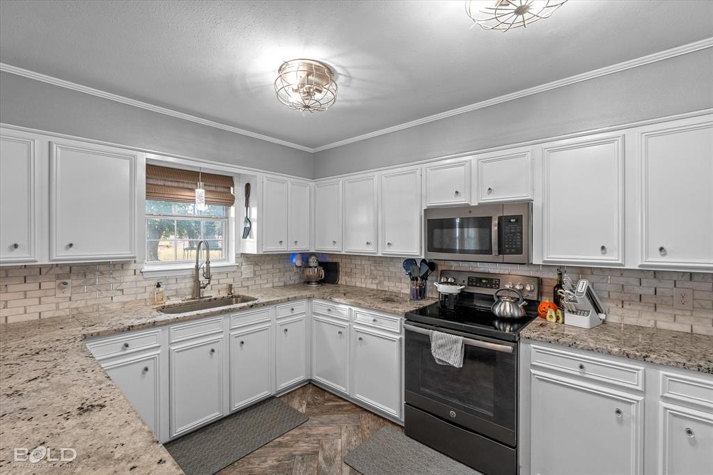 3804 Farmridge Road Keithville, LA 71047 - Photo 23 of 36 a kitchen with cabinets appliances a sink and a window