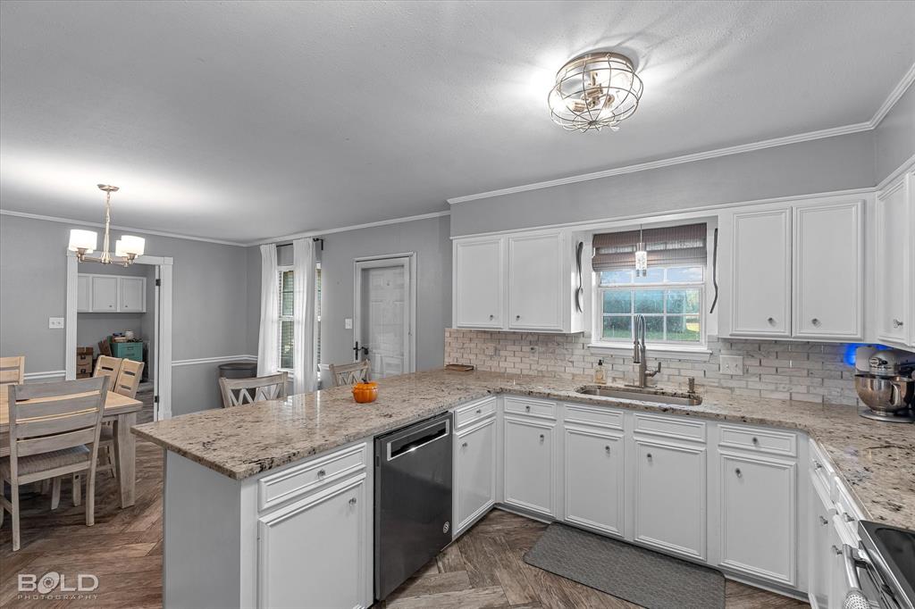 3804 Farmridge Road Keithville, LA 71047 - Photo 24 of 36 a kitchen that has a lot of cabinets in it and granite countertop