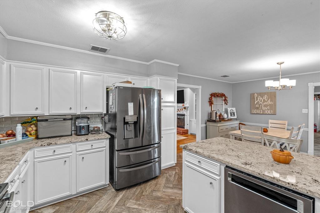 3804 Farmridge Road Keithville, LA 71047 - Photo 26 of 36 a kitchen with stainless steel appliances granite countertop a refrigerator sink and cabinets