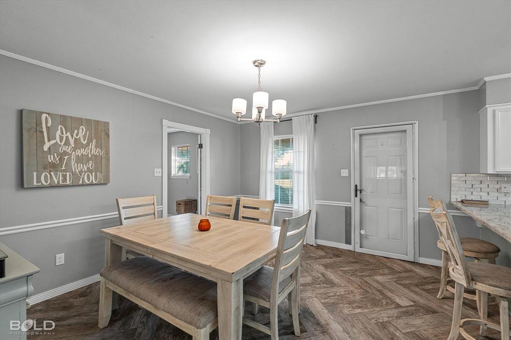 3804 Farmridge Road Keithville, LA 71047 - Photo 27 of 36 a view of a dining room with furniture and chandelier