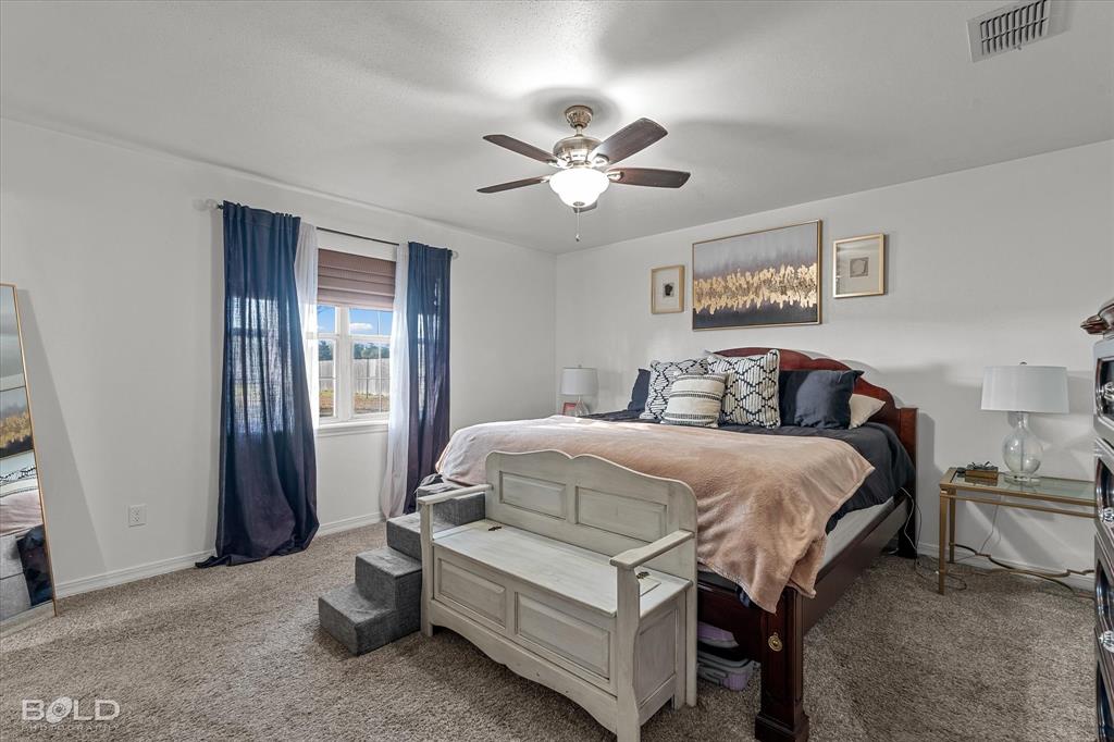 3804 Farmridge Road Keithville, LA 71047 - Photo 28 of 36 a bedroom with a bed and a chandelier