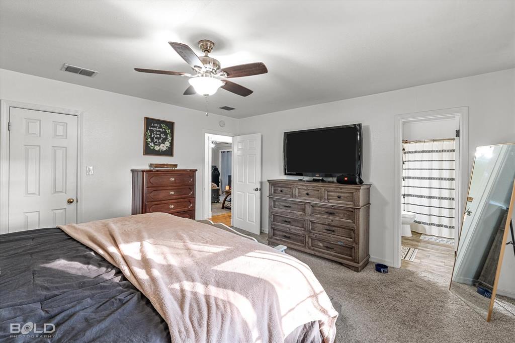 3804 Farmridge Road Keithville, LA 71047 - Photo 29 of 36 a bedroom with a bed and a flat screen tv