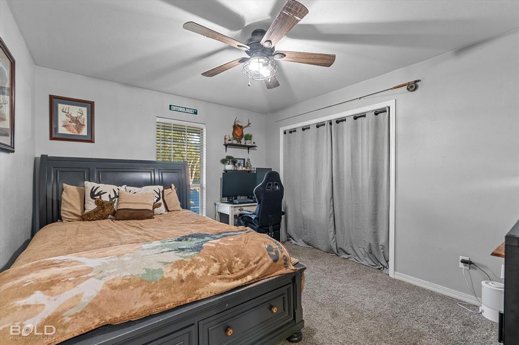 3804 Farmridge Road Keithville, LA 71047 - Photo 31 of 36 a bedroom with a bed and a chandelier