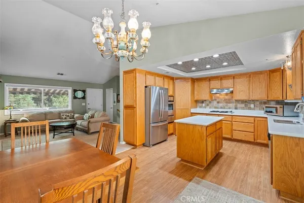 a kitchen with stainless steel appliances granite countertop a sink a stove and a refrigerator