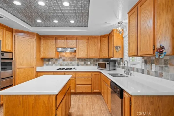 a kitchen with stainless steel appliances a refrigerator and a stove top oven