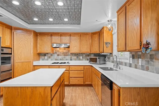 a kitchen with stainless steel appliances a refrigerator and a stove top oven
