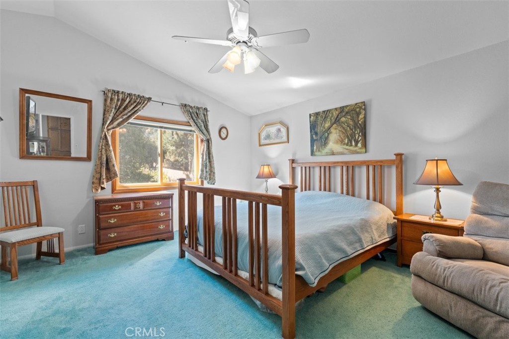 1585 Linnet Road Wrightwood, CA 92397 - Photo 16 of 38 a bedroom with a bed and a chandelier