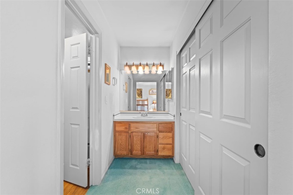 1585 Linnet Road Wrightwood, CA 92397 - Photo 21 of 38 a bathroom with a double vanity sink and a mirror