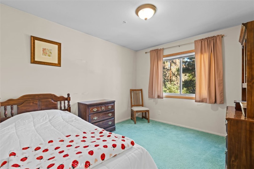 1585 Linnet Road Wrightwood, CA 92397 - Photo 23 of 38 a bedroom with a bed and a cabinets