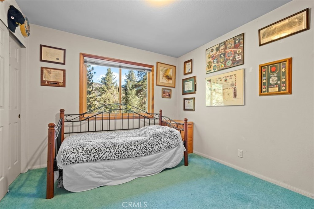 1585 Linnet Road Wrightwood, CA 92397 - Photo 24 of 38 a bed sitting in a bedroom next to a window