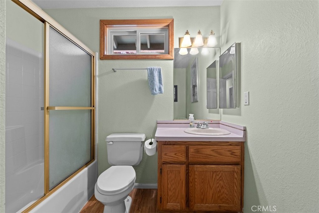 1585 Linnet Road Wrightwood, CA 92397 - Photo 25 of 38 a bathroom with a toilet sink and mirror