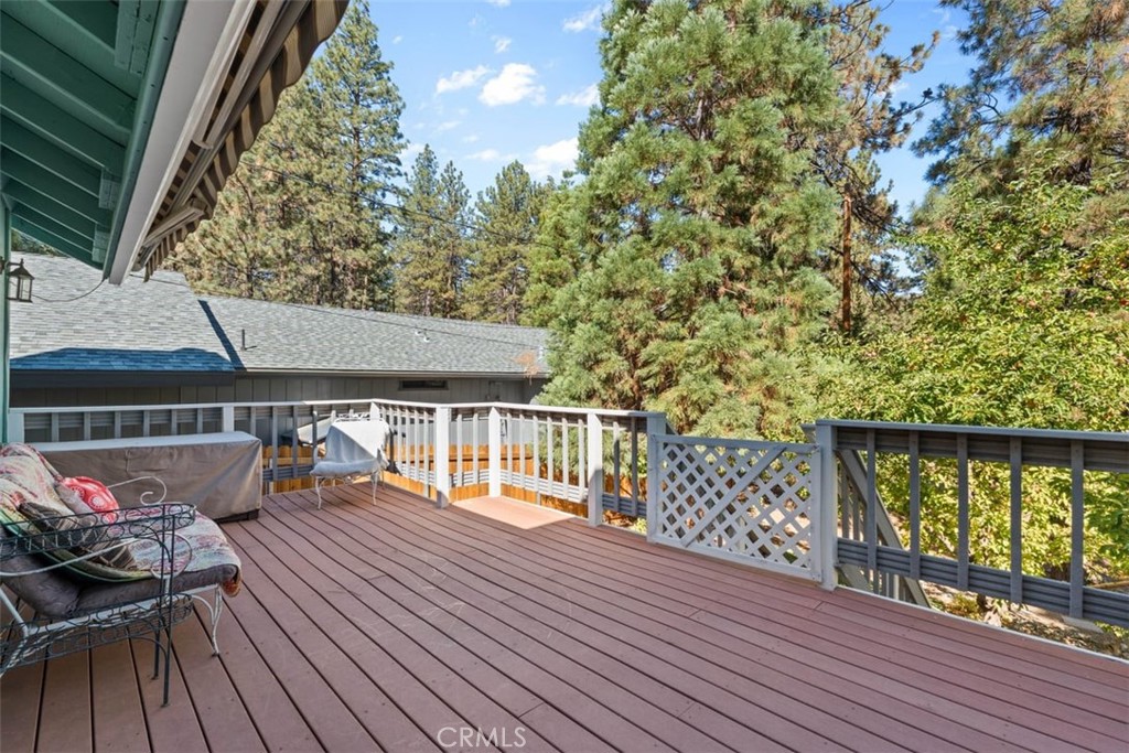 1585 Linnet Road Wrightwood, CA 92397 - Photo 8 of 38 a balcony with wooden floor table and chairs