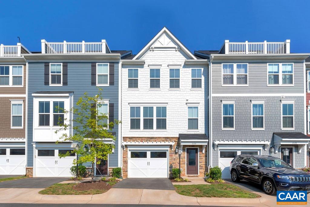 a front view of a residential apartment building with a yard