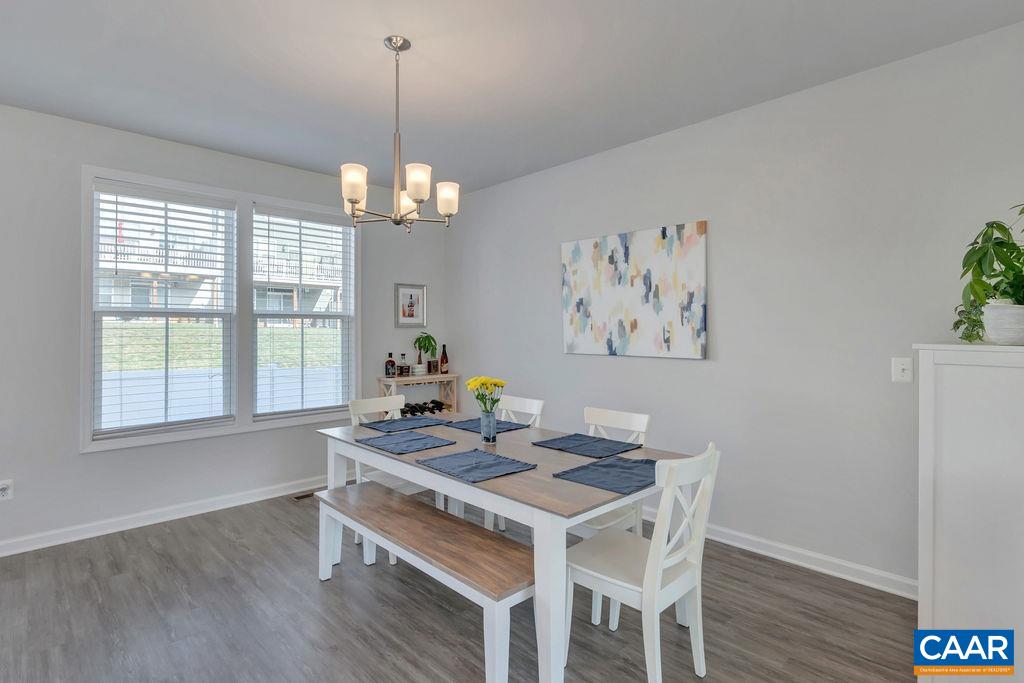 2176 Avinity Loop Charlottesville, VA 22902 - Photo 16 of 50 a dining room with wooden floor and a chandelier
