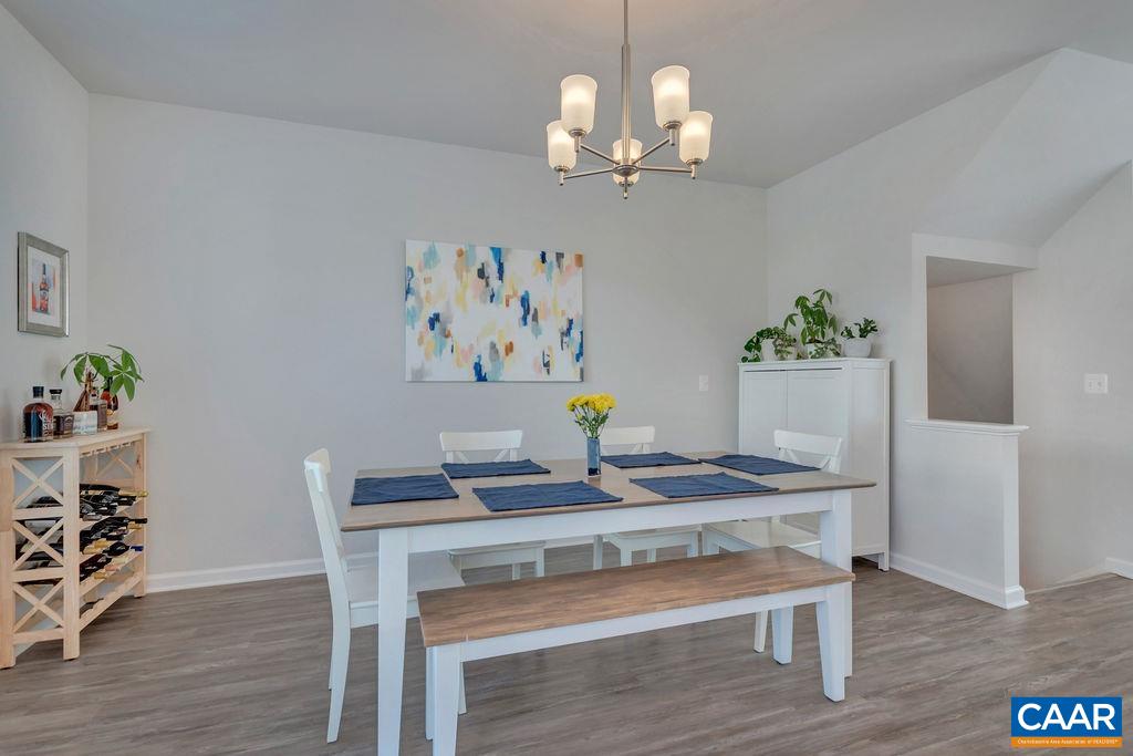 2176 Avinity Loop Charlottesville, VA 22902 - Photo 17 of 50 a view of a dining room with furniture and wooden floor