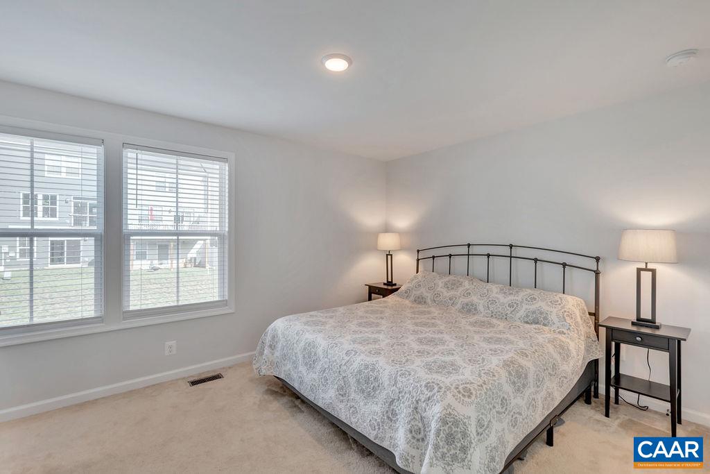 2176 Avinity Loop Charlottesville, VA 22902 - Photo 22 of 50 a large bed sitting in a bedroom next to a window