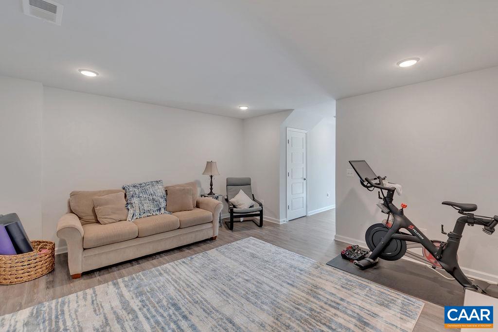 2176 Avinity Loop Charlottesville, VA 22902 - Photo 5 of 50 a living room with furniture a wooden floor and a potted plant