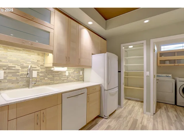 a kitchen with a refrigerator and a sink