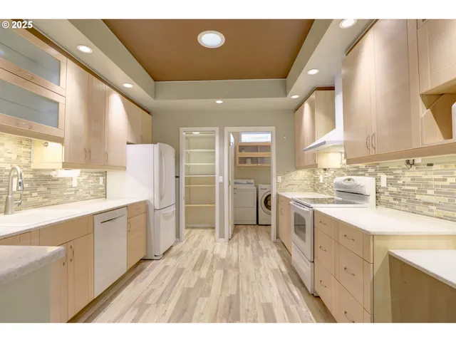 a large kitchen with kitchen island a sink stainless steel appliances and cabinets